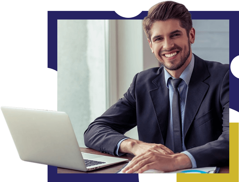 Portrait of Smiling Business Executive in Formal Suit Using a Laptop