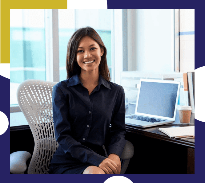 Smiling Young Business Executive at Her Desk